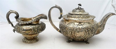 Lot 1114 - A George IV Irish Teapot and Cream Jug, the teapot C Marsh, Dublin 1820, the cream jug John...