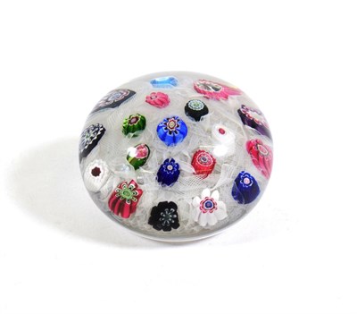 Lot 503 - A Clichy Spaced Millefiori Paperweight, circa 1850, set with nineteen canes on a white gauze...