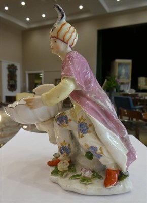 Lot 507 - A Chelsea Porcelain Figural Sweetmeat Dish, circa 1755, as a seated Turk holding a shell, on a...