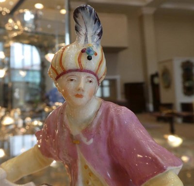 Lot 507 - A Chelsea Porcelain Figural Sweetmeat Dish, circa 1755, as a seated Turk holding a shell, on a...
