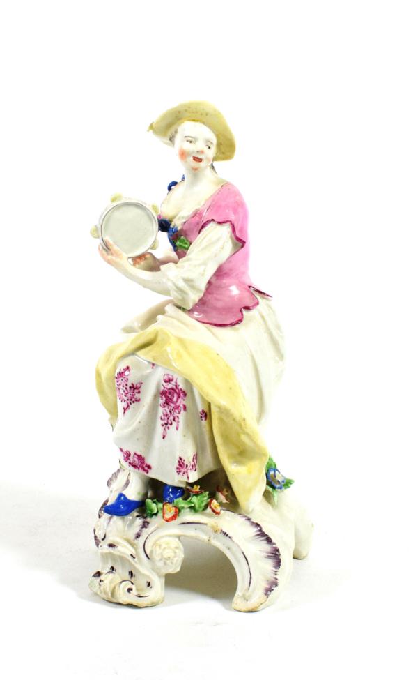 Lot 512 - A Bow Porcelain Figure of a Lady Musician, circa 1760, seated playing the tambourine, on a...