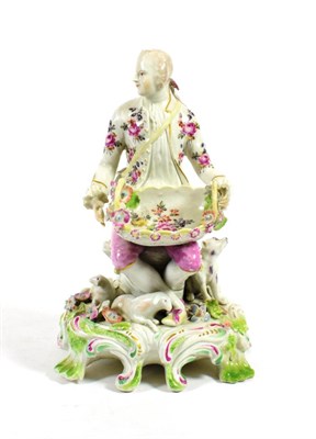 Lot 519 - A Derby Porcelain Sweetmeat Figure, circa 1758, as a gentleman sitting holding a basket, on a...