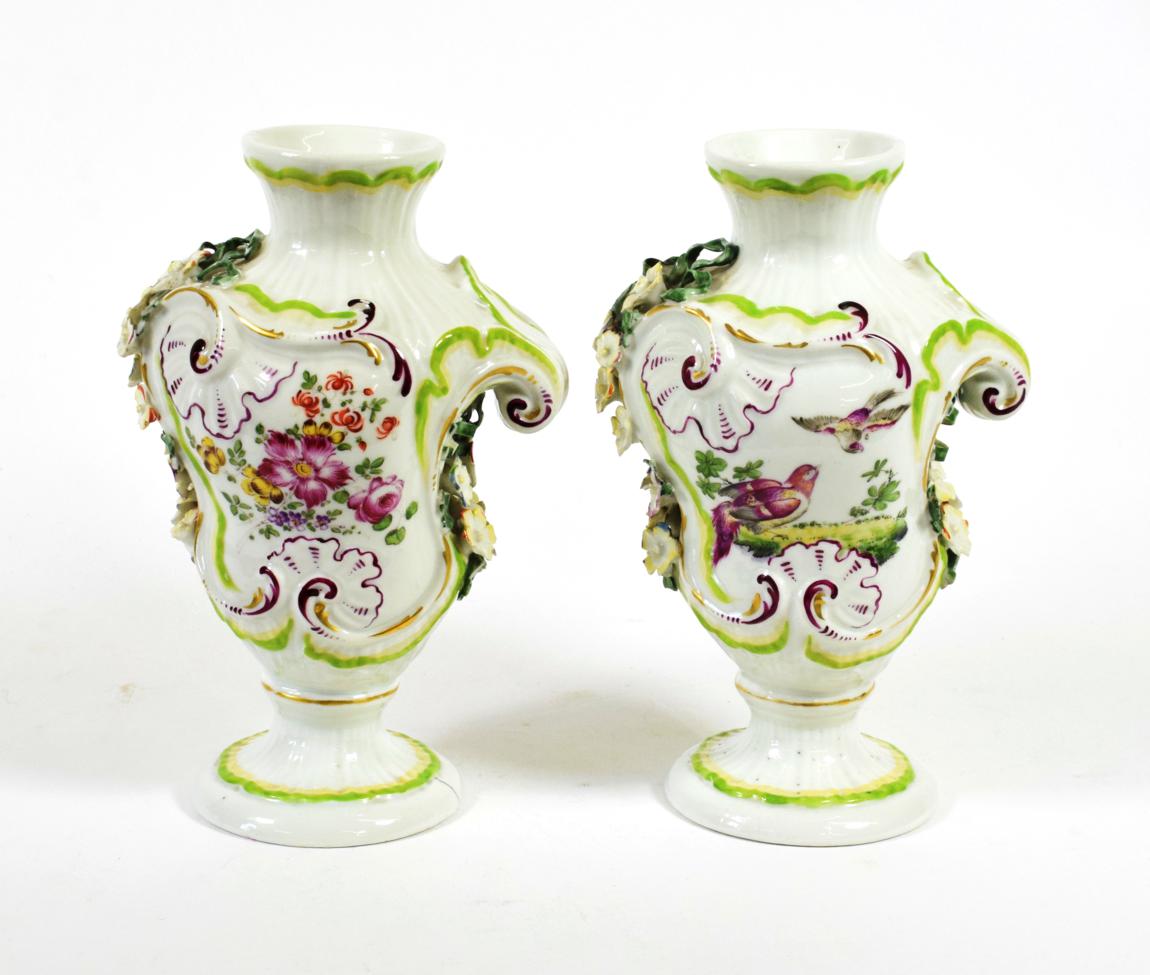 Lot 524 - A Pair of Derby Porcelain Rococo Scroll Moulded Vases, circa 1765, painted with birds in landscapes