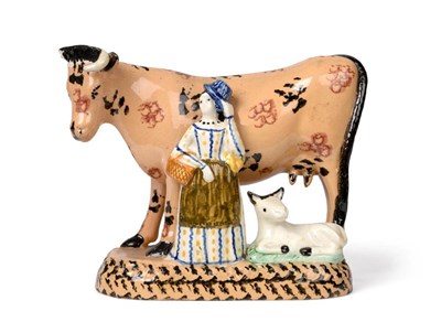 Lot 534 - A Yorkshire Pratt Type Cow Group, circa 1810, the buff coloured animal with black and brown...