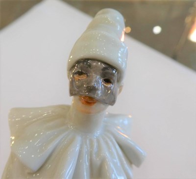 Lot 549 - A Meissen Porcelain Figure of Pierrot, 20th century, standing wearing a mask and white robes...
