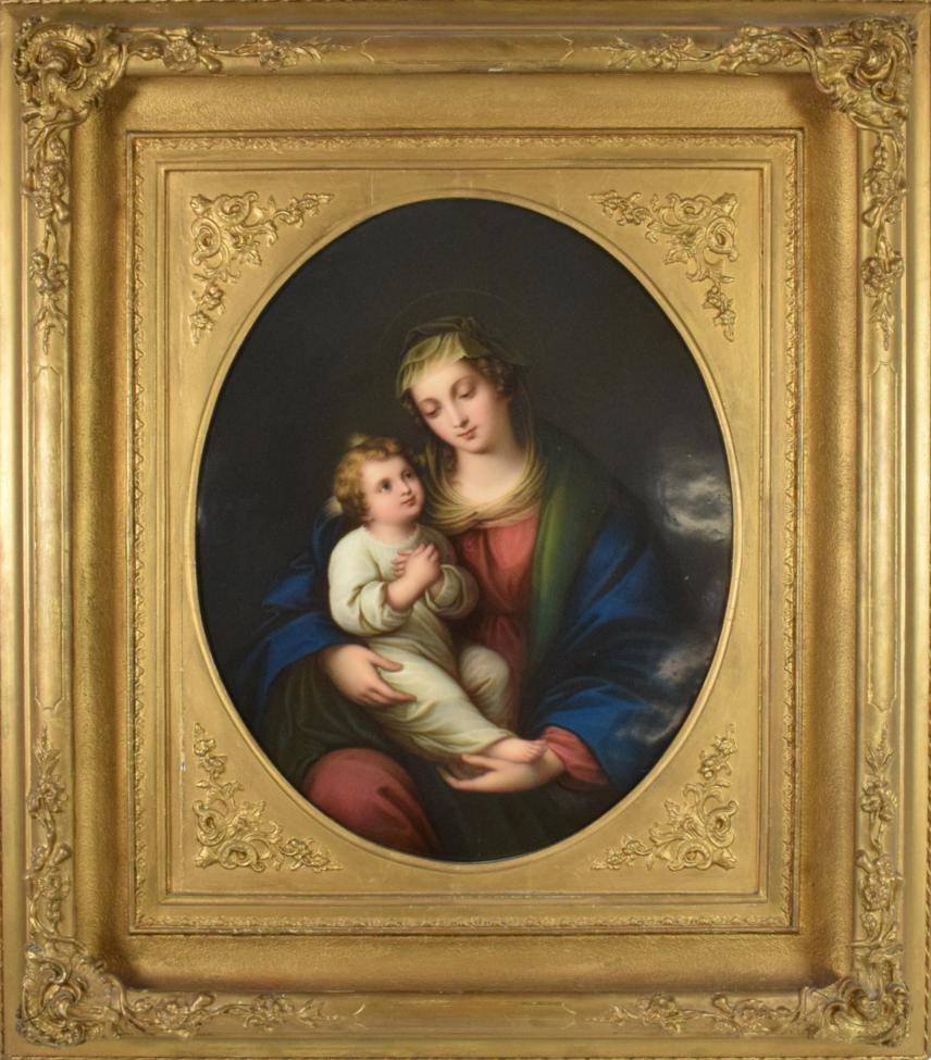 Lot 559 - A German Porcelain Plaque, circa 1860, of oval form, painted with the Madonna and Child, 42cm...
