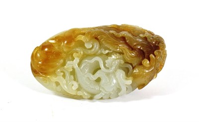 Lot 595 - A Chinese Celadon and Russet Jade Pebble, Qing Dynasty, carved with carp amongst waves, 8cm long