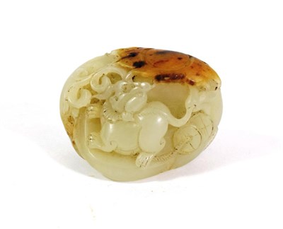 Lot 598 - A Chinese Celadon and Russet Jade Pebble, Qing Dynasty, carved with a rat amongst foliage,...