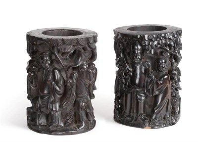 Lot 610 - A Pair of Chinese Black Wood Brush Pots, Qing Dynasty, carved with figures amongst trees, 21cm high