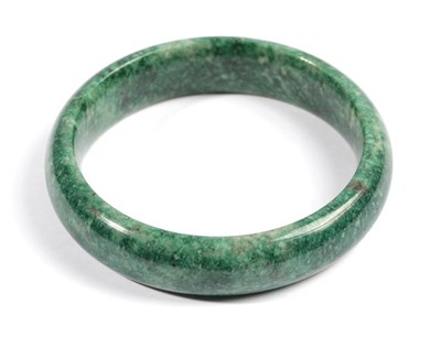 Lot 612 - A Jade Bangle, of varied green tones, inner diameter 6.5cm  Provenance: Purchased by the...