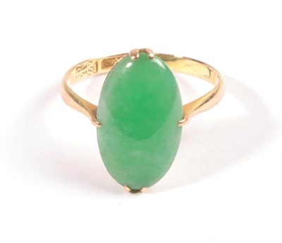 Lot 614 - A Jade Ring, the oval cabochon held in yellow claw, to a tapered shoulder plain polished shank,...