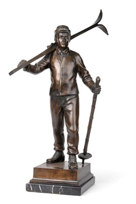 Lot 628 - German School (early 20th century): A Bronze Figure of a Skier, walking holding his skis over...