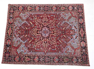 Lot 662 - Heriz Carpet North West Iran, circa 1910 The claret field of angular leafy vines centred by a...