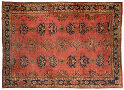 Lot 669 - Ushak Carpet Central West Anatolia, circa 1890 The coral pink field with columns of medallions...