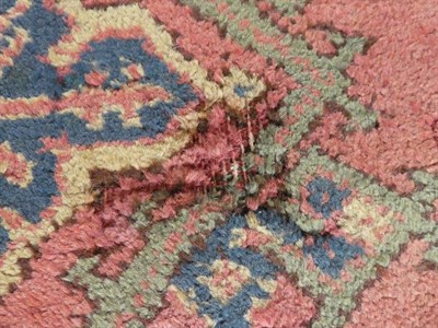 Lot 669 - Ushak Carpet Central West Anatolia, circa 1890 The coral pink field with columns of medallions...