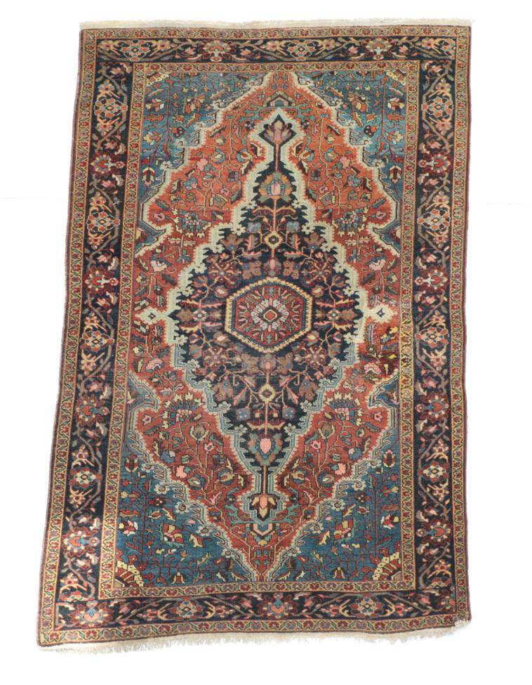 Lot 670 - Feraghan Saroukh Rug West Iran, circa 1930 The terracotta field of angular vines around an...