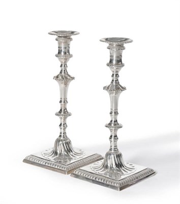 Lot 1135 - A Matched Pair of George III Candlesticks, one John Cafe, London 1776, the other maker's mark...