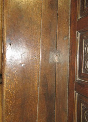 Lot 688 - A Joined Oak Settle, late 17th/18th century, the back support carved in relief with five panels...