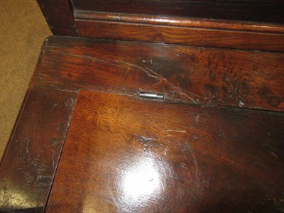 Lot 689 - A George III Joined Oak Settle, early 19th century, the back support with four moulded panels...