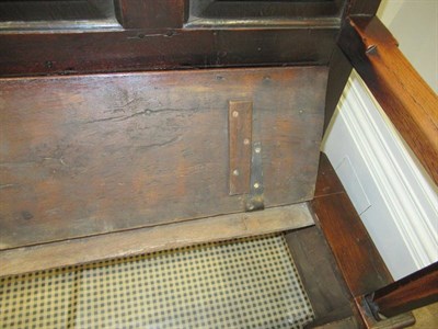 Lot 689 - A George III Joined Oak Settle, early 19th century, the back support with four moulded panels...