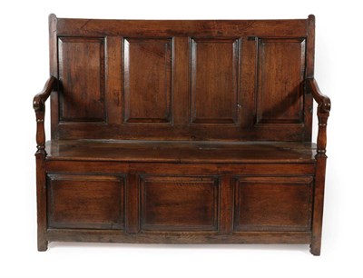 Lot 690 - A George III Joined Oak Settle, late 18th century, the back support with four moulded panels...