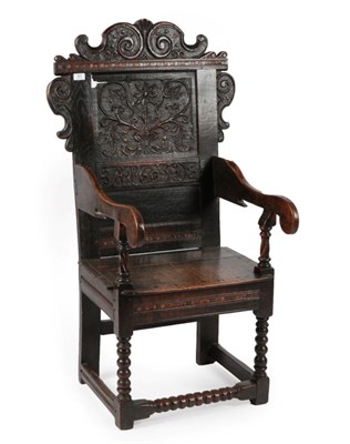 Lot 691 - A 17th Century Joined Oak Wainscot Armchair, dated and initialled 1605 AID, the scrolled top...