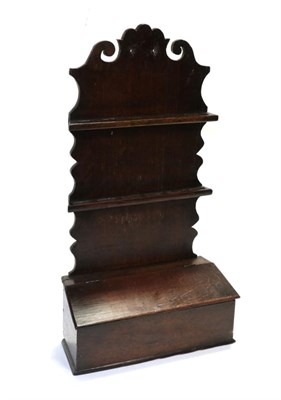 Lot 697 - An Oak Spoon Rack, late 18th century, the scrolled back supporting two racks with apertures for six