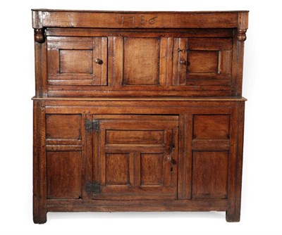 Lot 707 - An 18th Century Joined Oak Cupboard, dated 1716, the boarded top above inverted turned finials, the