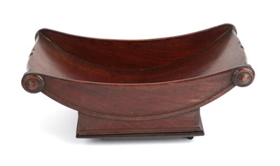 Lot 737 - A Mahogany Cheese Coaster, early 19th century, of boat shape with scrolled and moulded handles, the