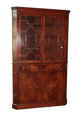 Lot 746 - A George III Mahogany and Boxwood Strung Freestanding Corner Cupboard, circa 1800, the moulded...