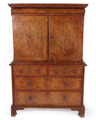Lot 757 - ~ A George I Figured Walnut and Feather-Banded Cabinet on Stand, early 18th century, with...