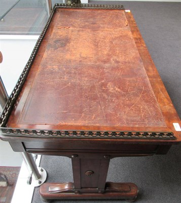 Lot 762 - ~ An Early Victorian Mahogany Writing Table, mid 19th century, the pierced brass three-quarter...
