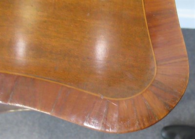 Lot 768 - ~ A George III Mahogany Serpentine Shaped and Crossbanded Writing Table, circa 1800, with a...