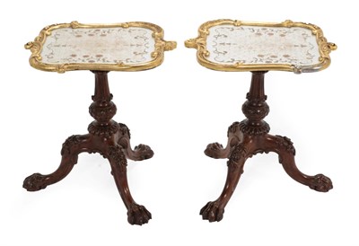 Lot 771 - A Pair of Carved Rosewood and Parcel Gilt Tripod Tables, the associated verre eglomise tops on...