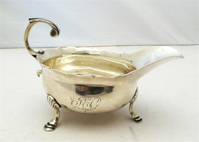 Lot 1147 - A George II Oval Sauce Boat, John Payne, London 1750, with leaf sheathed scroll handle and ogee rim