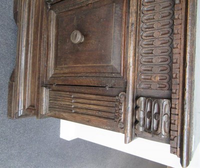 Lot 805 - A 17th Century Italian Carved Walnut Cupboard, the hinged lid above a nulled frieze with...
