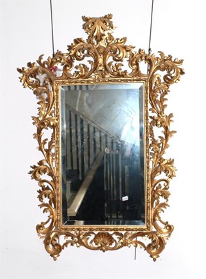 Lot 817 - A 19th Century Italian Rococo Carved Giltwood Mirror, the bevelled glass plate within a...