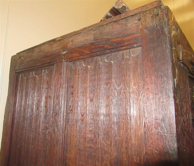 Lot 701 - A 17th Century Joined and Carved Oak Cupboard, with four hinged doors carved with sixteen...