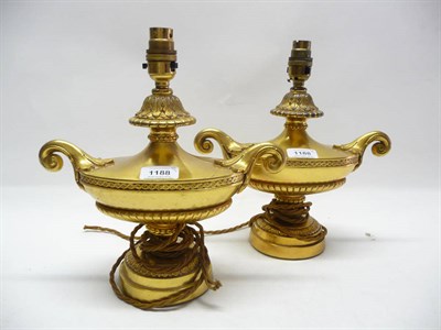 Lot 1188 - A Pair of George III Style Gilt Metal Urn Shaped Lamp Bases, of oval form with leaf sheathed...