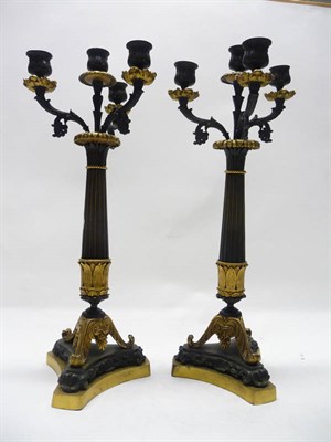 Lot 1189 - A Pair of Empire Style Three-Branch Bronze Candelabra, each with central sconces and three...