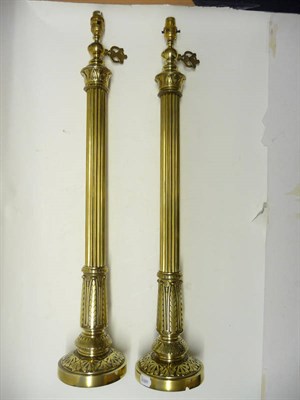 Lot 1190 - A Pair of Brass Table Lamps, late 19th century, with foliate taps, leaf sheathed capitals,...