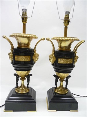 Lot 1191 - A Pair of Gilt Metal and Bronzed Table Lamps, in 18th century style, with gadrooned rims and...