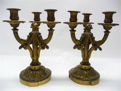 Lot 1192 - A Pair of  Gilt Bronze Three-Branch Candelabra, in Louis XIV Style, early 20th century, with beaded