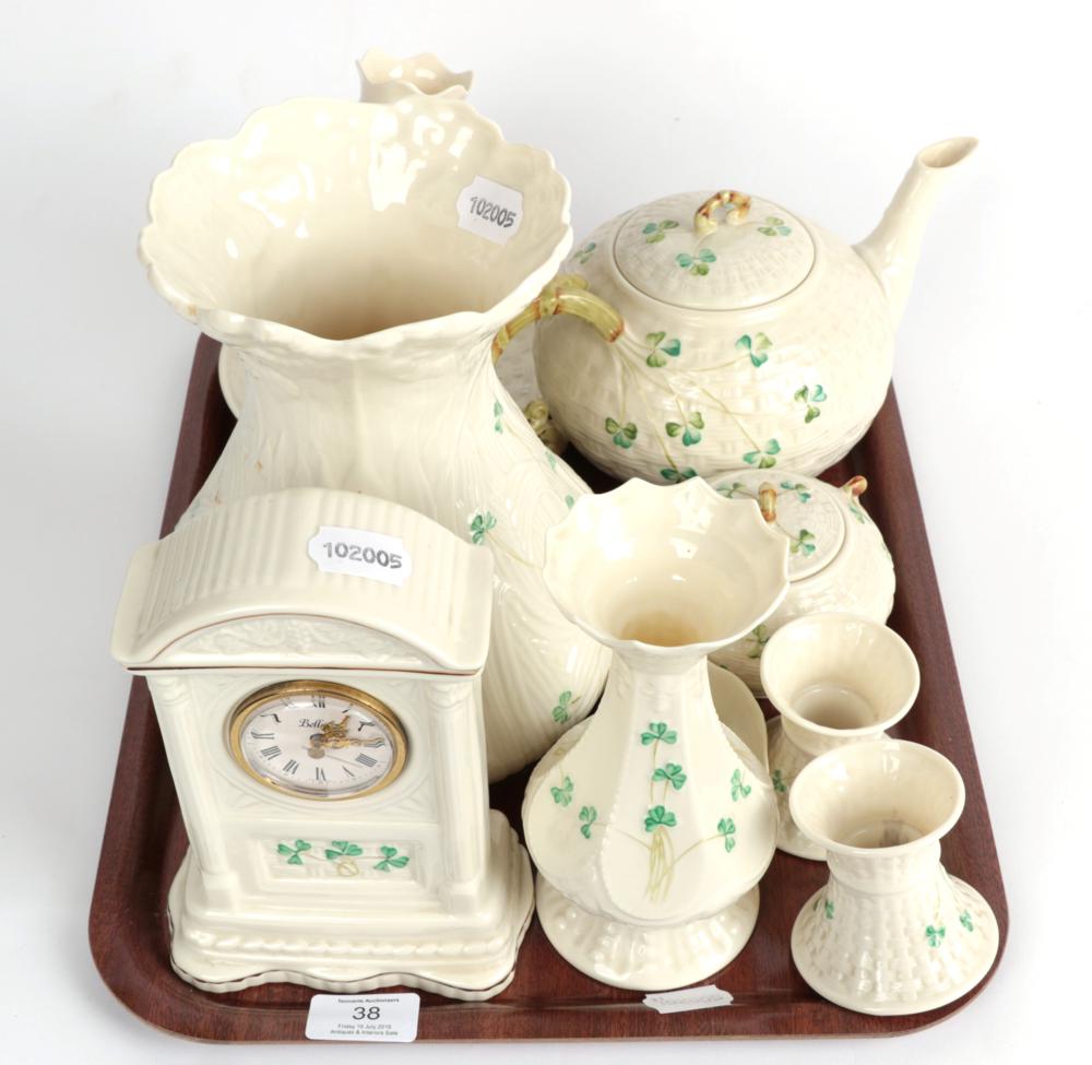 Lot 38 - ^ A tray of Belleek china comprising: mantle clock; teapot; two cups and saucers; sugar bowl;...