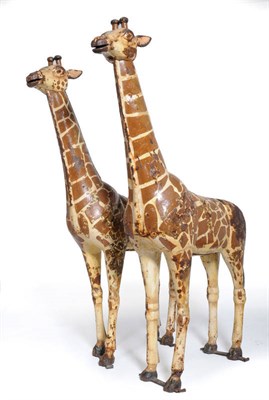 Lot 1197 - A Pair of Painted Metal Fairground Ride Giraffes, early 20th century, each in naturalistic standing