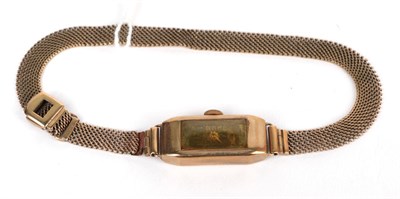 Lot 72 - A lady's 9 carat gold rectangular shaped wristwatch, with attached mesh bracelet and clasp...