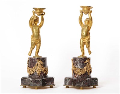 Lot 1201 - A Pair of Ormolu Figural Candlesticks, French, circa 1870, modelled as individual scantily clad...