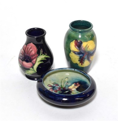 Lot 96 - A Moorcroft Spring Flowers pattern circular shallow bowl; a hibiscus pattern vase; and an...