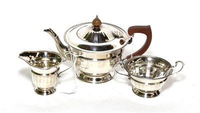 Lot 97 - A silver three piece tea service, Collingwood & Sons, Birmingham 1935, circular with bead...