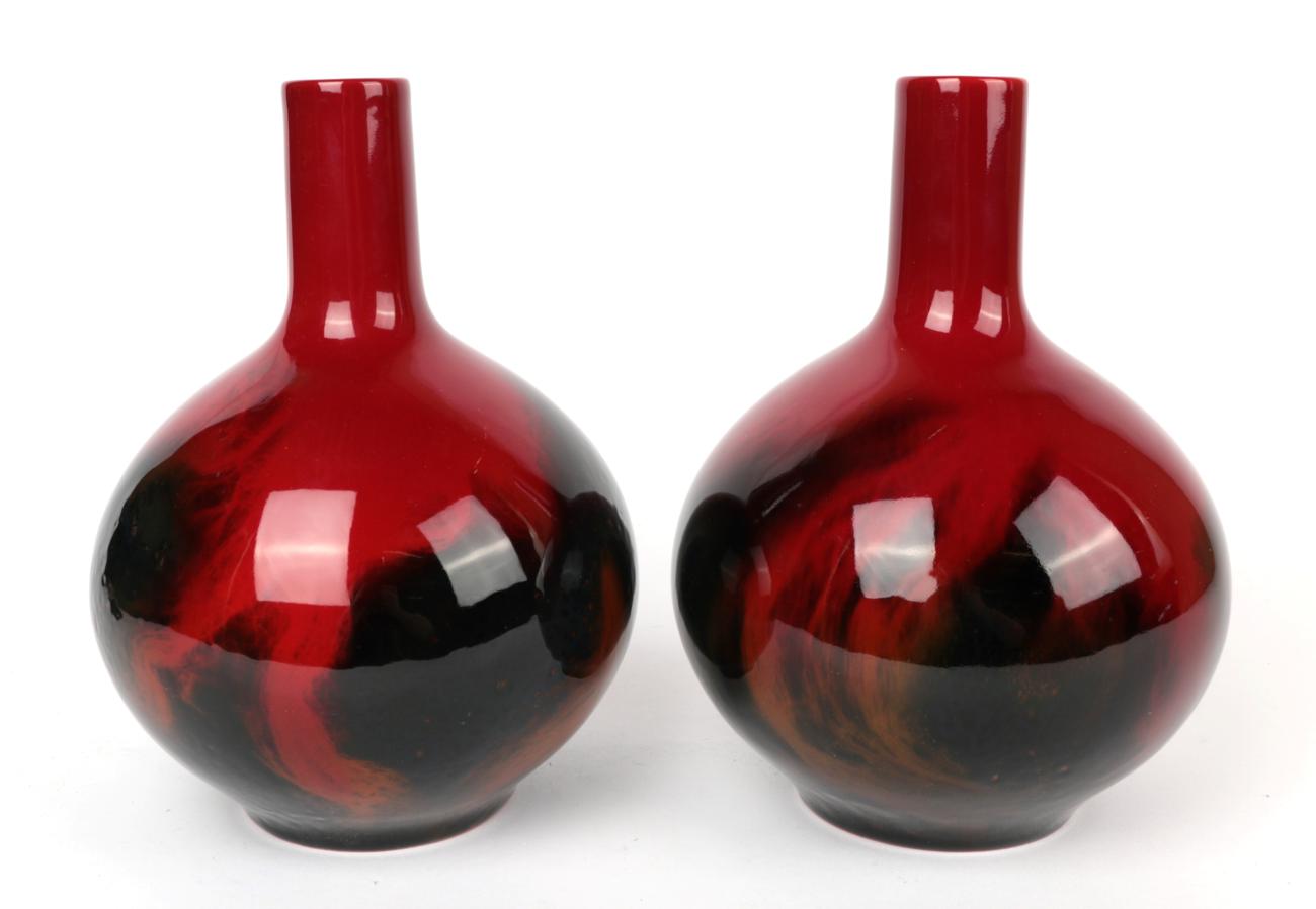 Lot 114 - A pair of Royal Doulton Flambe bottle vases, shape number 1618